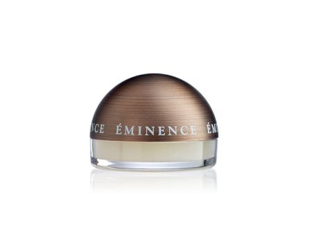 A small &ldquo;EMINENCE&rdquo; cosmetic jar/cream container with a wood-toned lid and clear reflective base.